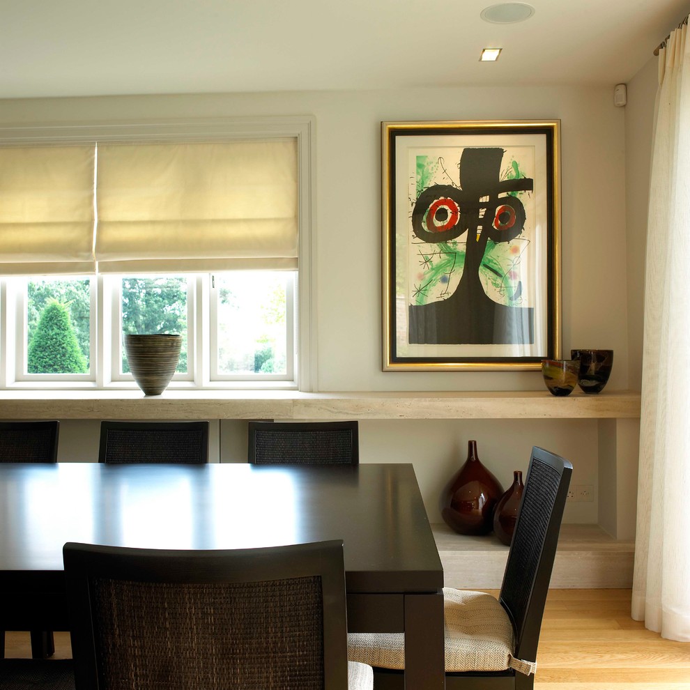 Photo of a large contemporary enclosed dining room in West Midlands with white walls and light hardwood flooring.