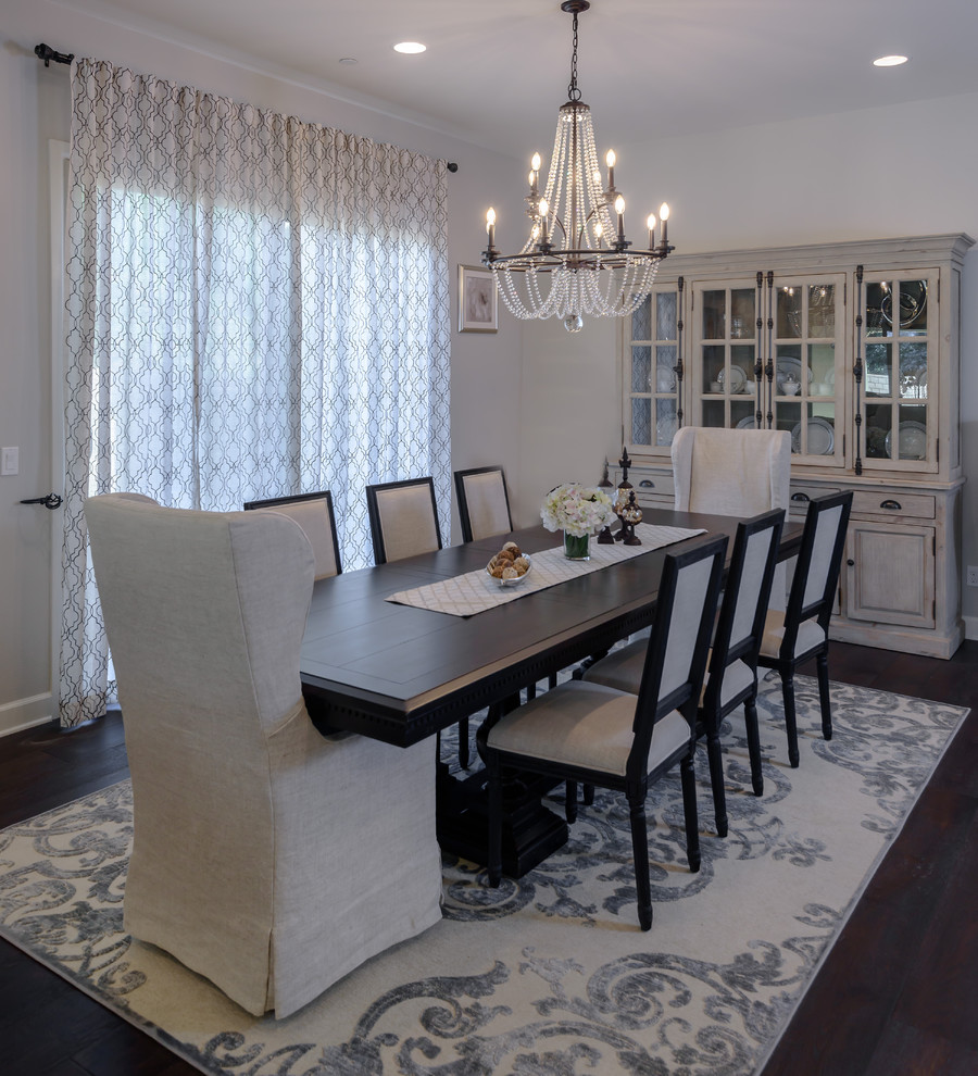 Photo of a medium sized traditional enclosed dining room in Orange County with white walls, dark hardwood flooring, no fireplace and brown floors.
