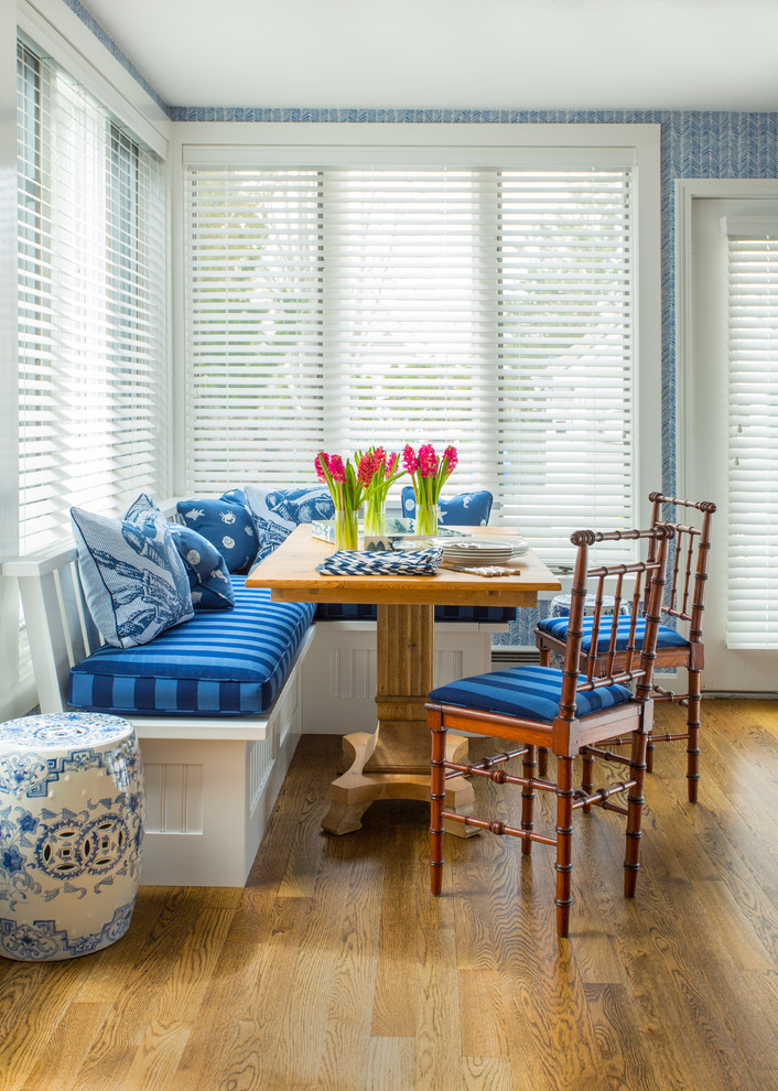 Inspiration for a mid-sized timeless medium tone wood floor dining room remodel in Boston with blue walls
