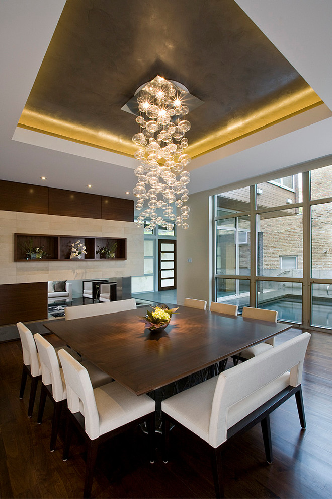 Inspiration for a contemporary dining room in Chicago with a corner fireplace.