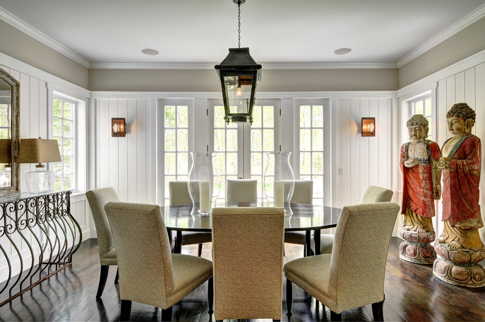 Example of a large classic dark wood floor enclosed dining room design in New York with beige walls