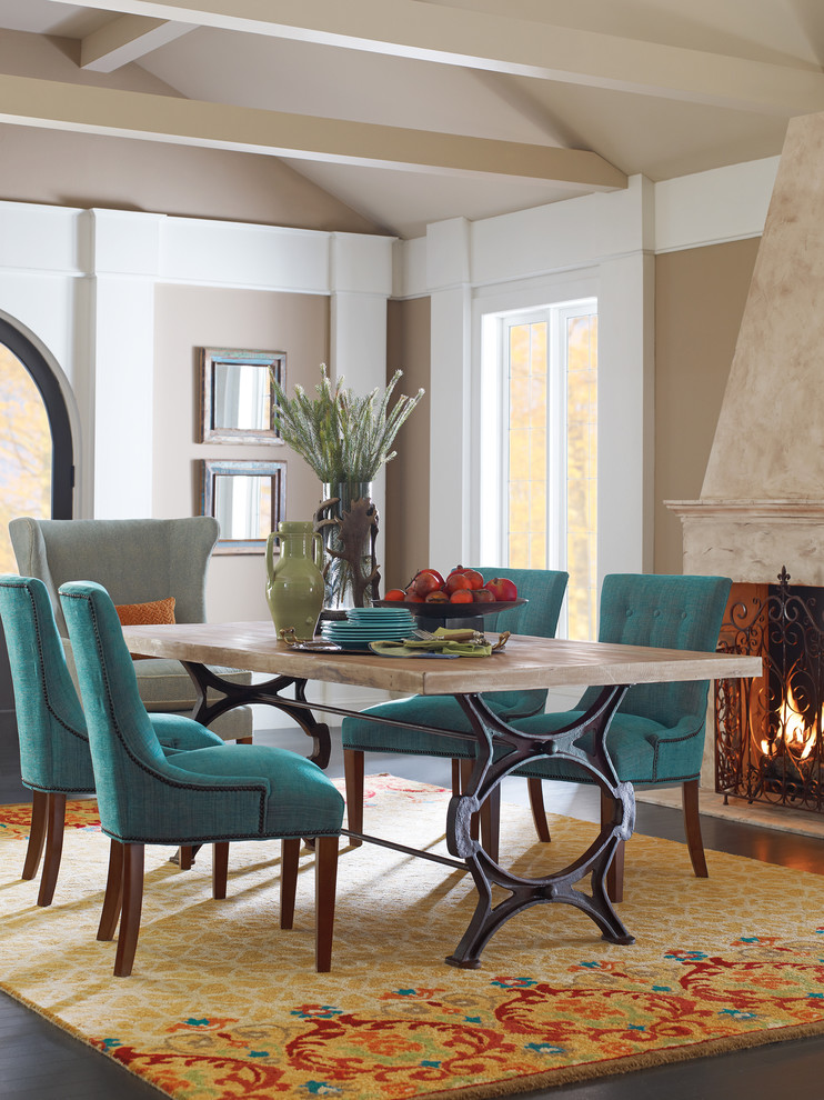 Exemple d'une grande salle à manger ouverte sur le salon tendance avec un mur beige, parquet foncé, une cheminée standard, un manteau de cheminée en pierre et un sol marron.