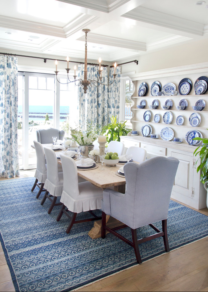Immagine di una sala da pranzo stile marinaro con pareti beige, parquet chiaro e nessun camino