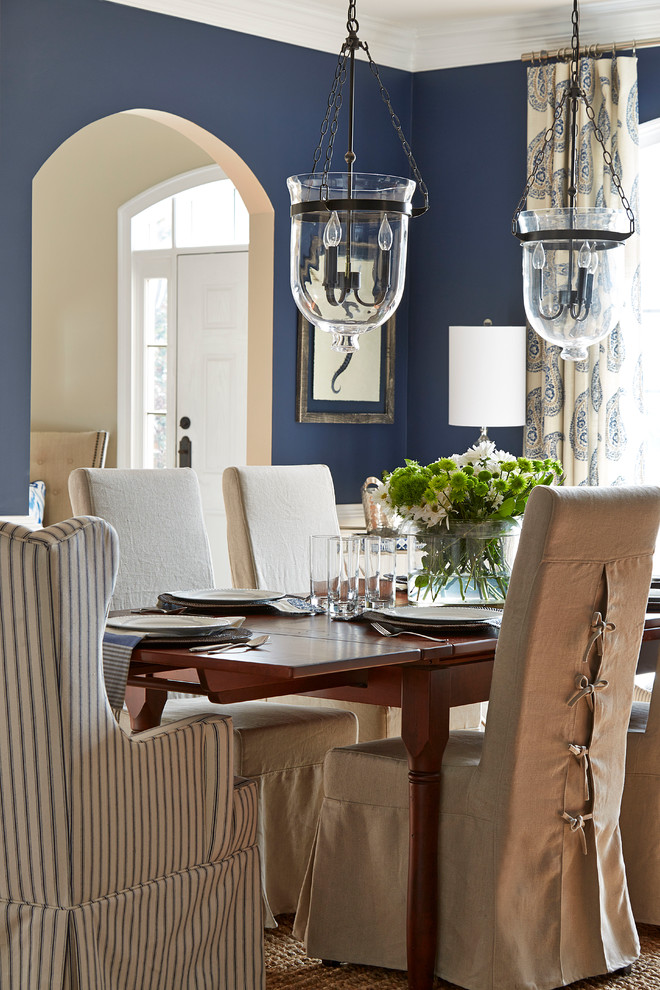 This is an example of a classic open plan dining room in Atlanta with blue walls and feature lighting.