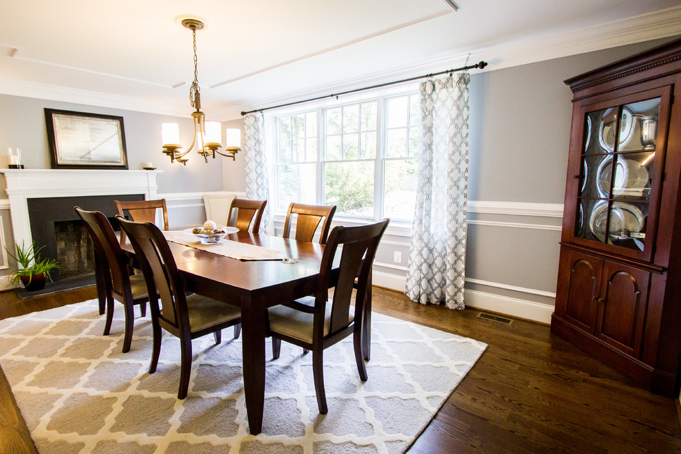 Photo of a medium sized classic enclosed dining room in Philadelphia with grey walls, medium hardwood flooring, a standard fireplace, a metal fireplace surround and brown floors.