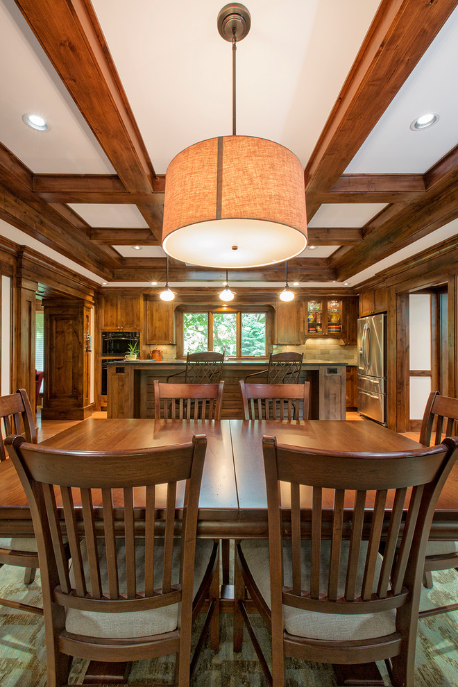 Inspiration for a large craftsman medium tone wood floor great room remodel in Omaha with white walls and no fireplace