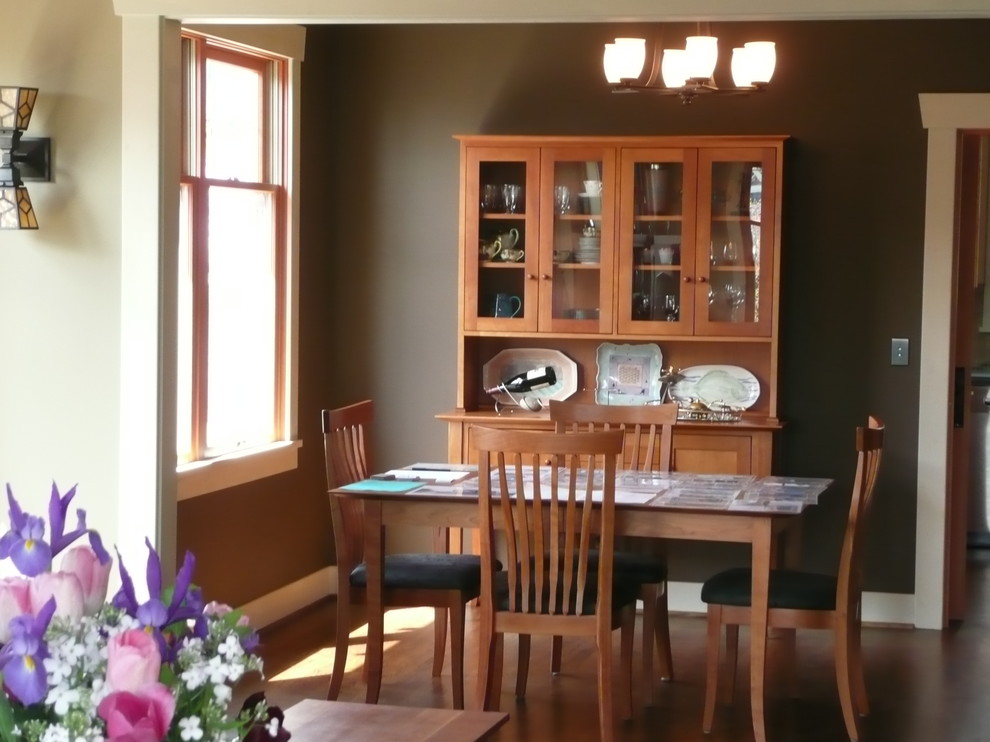 This is an example of a small traditional enclosed dining room in Seattle with brown walls, medium hardwood flooring, no fireplace and brown floors.