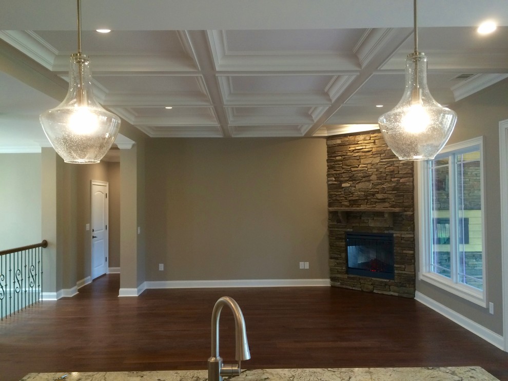 Photo of a medium sized classic kitchen/dining room in Other with beige walls, dark hardwood flooring, a corner fireplace, a stone fireplace surround and brown floors.