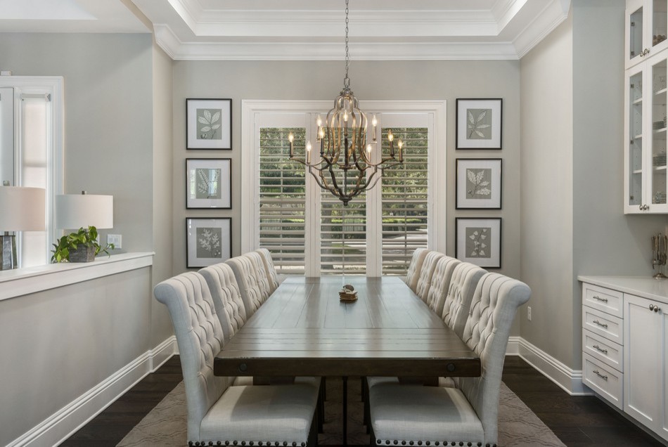 Large traditional open plan dining room in Orlando with grey walls, dark hardwood flooring and feature lighting.