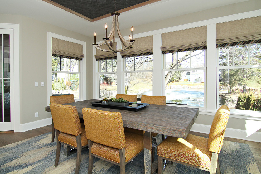 Large classic enclosed dining room in Minneapolis with beige walls, dark hardwood flooring and no fireplace.