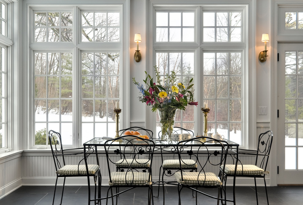 Dining room - traditional slate floor and black floor dining room idea in New York