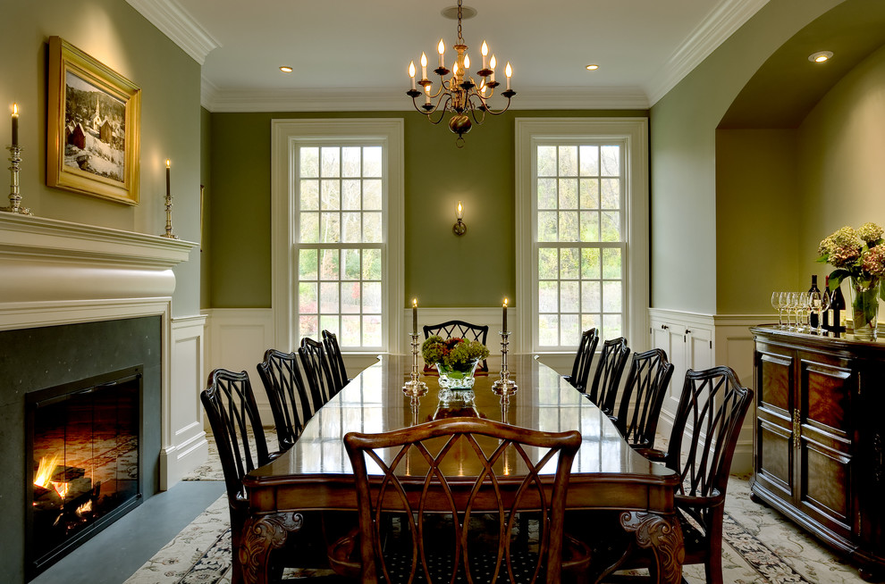 Elegant carpeted dining room photo in New York with green walls and a standard fireplace