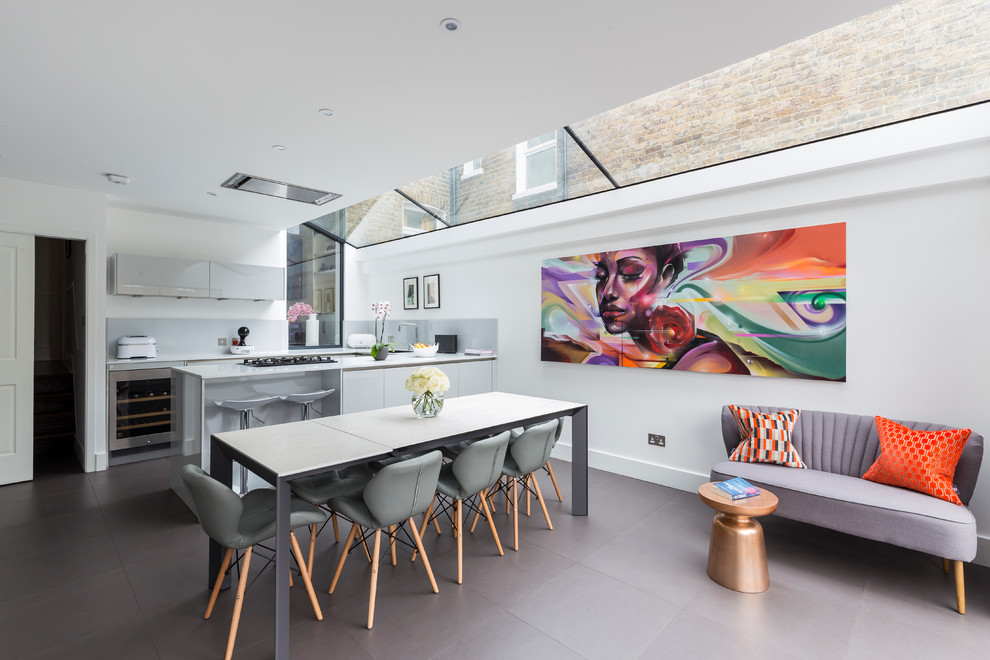 Contemporary open plan dining room in London with white walls.