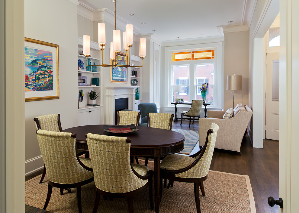 Mid-sized elegant medium tone wood floor enclosed dining room photo in DC Metro with white walls, a standard fireplace and a wood fireplace surround