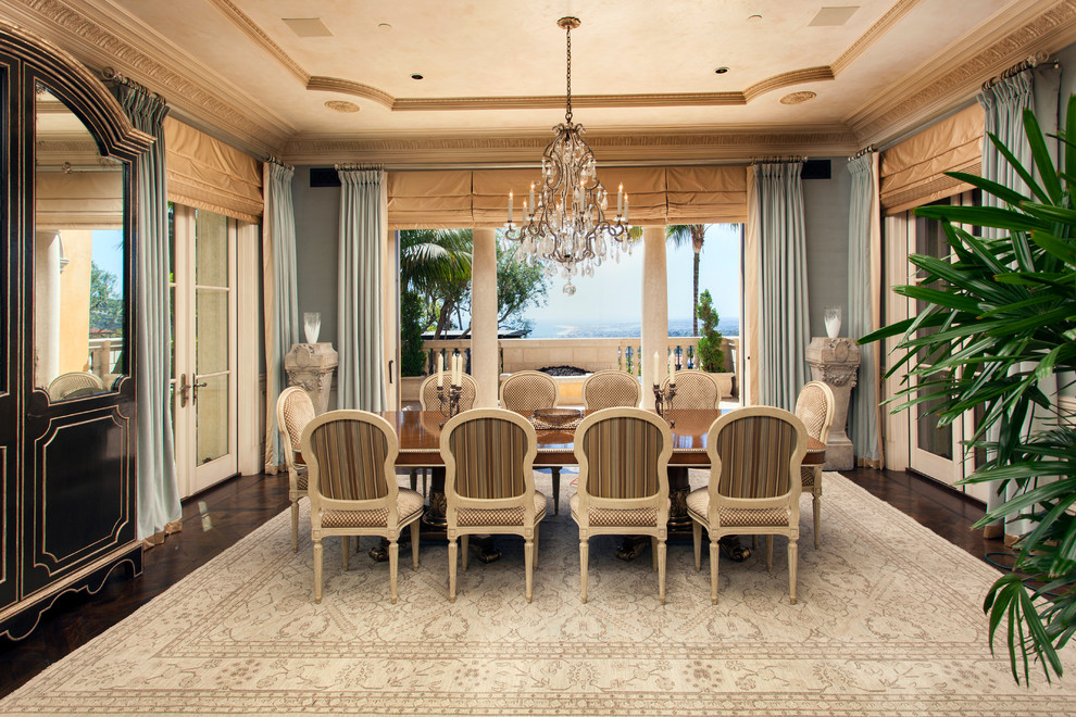 This is an example of a mediterranean enclosed dining room in Orange County with blue walls, dark hardwood flooring and brown floors.