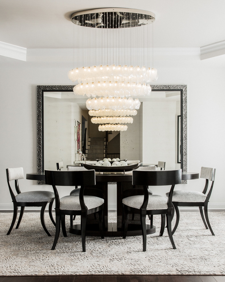 This is an example of a large contemporary dining room in New York with no fireplace and white walls.