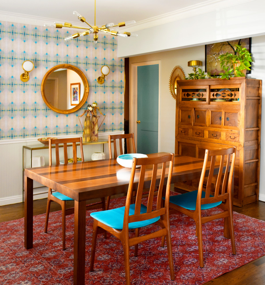 Small bohemian enclosed dining room in Los Angeles with white walls, medium hardwood flooring and brown floors.