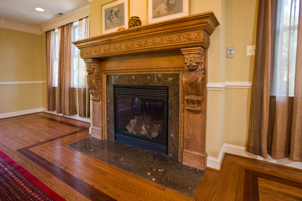 Mid-sized elegant medium tone wood floor enclosed dining room photo in Baltimore with beige walls and a standard fireplace