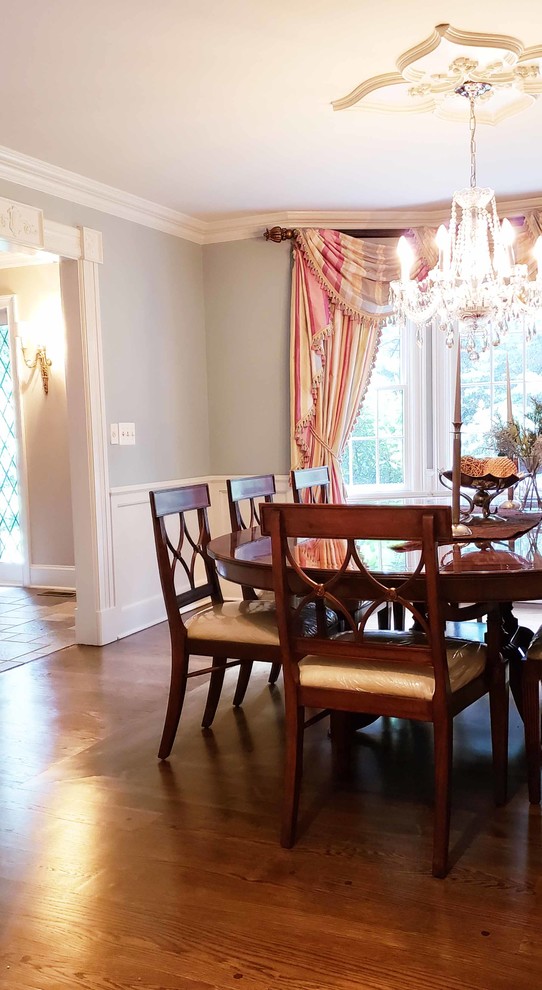 Large classic kitchen/dining room in New York with blue walls, dark hardwood flooring, no fireplace and brown floors.