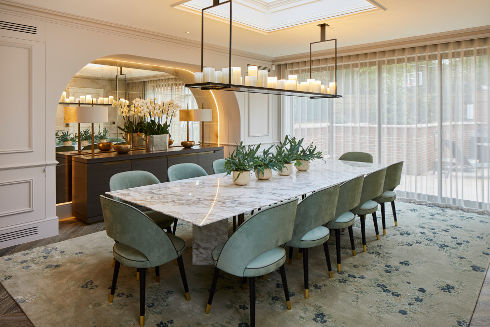 Foto de comedor tradicional renovado grande cerrado sin chimenea con paredes beige, suelo de madera en tonos medios, suelo marrón y panelado