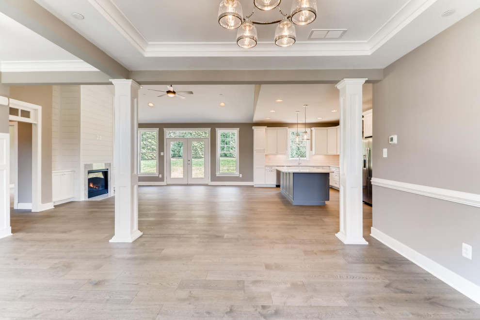 Photo of an expansive classic dining room in Baltimore with brown walls, light hardwood flooring and grey floors.