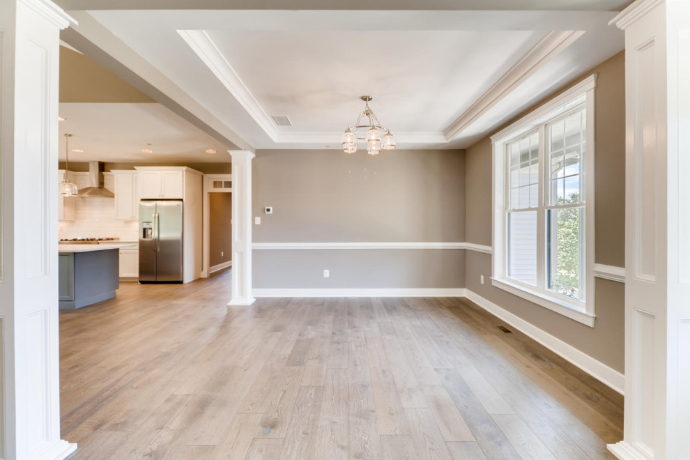 Expansive traditional dining room in Baltimore with brown walls, light hardwood flooring and grey floors.