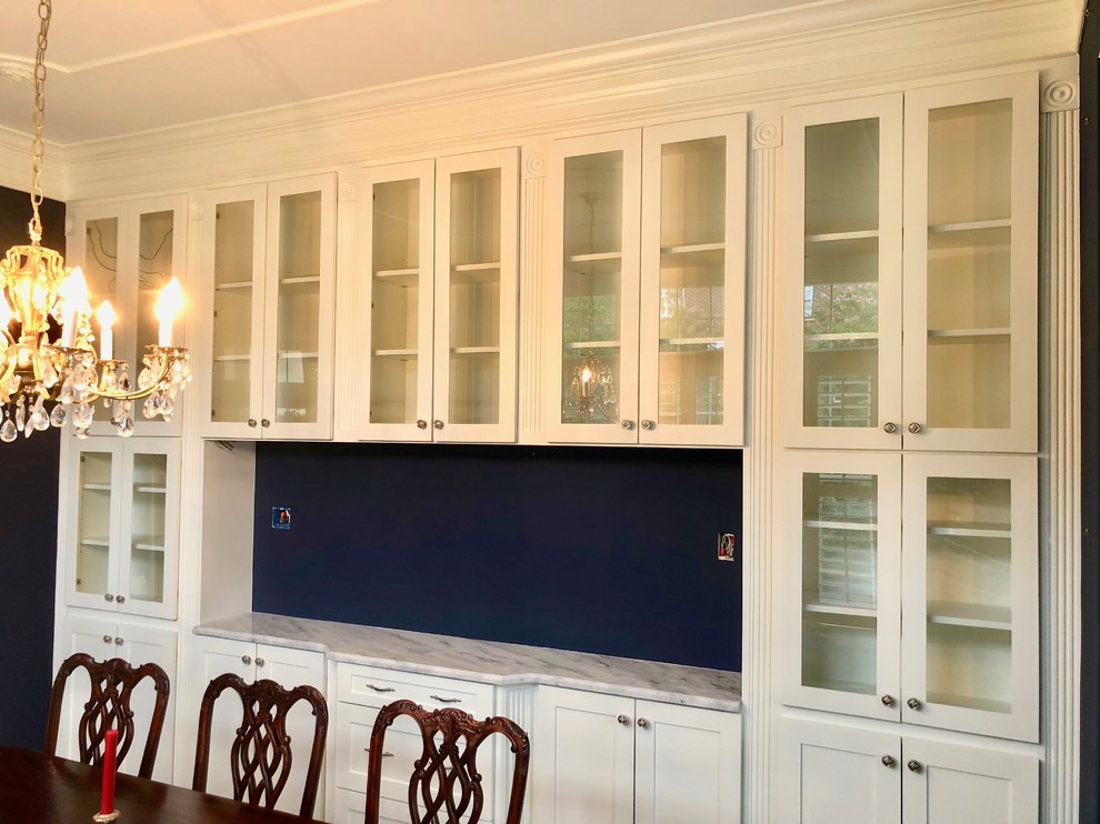 Medium sized classic enclosed dining room in DC Metro with blue walls, dark hardwood flooring and brown floors.