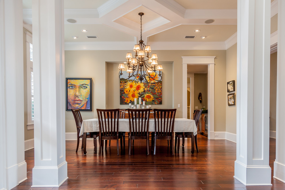 Enclosed dining room - large traditional medium tone wood floor enclosed dining room idea in Jacksonville with beige walls