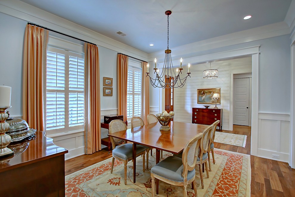 Photo of a medium sized traditional enclosed dining room in Charleston with blue walls and medium hardwood flooring.