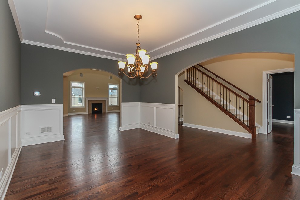 This is an example of a medium sized traditional enclosed dining room in Chicago with grey walls, medium hardwood flooring, no fireplace and brown floors.