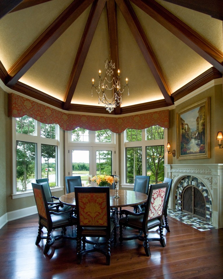 Example of a large classic medium tone wood floor and brown floor enclosed dining room design in Cleveland with brown walls, a standard fireplace and a tile fireplace