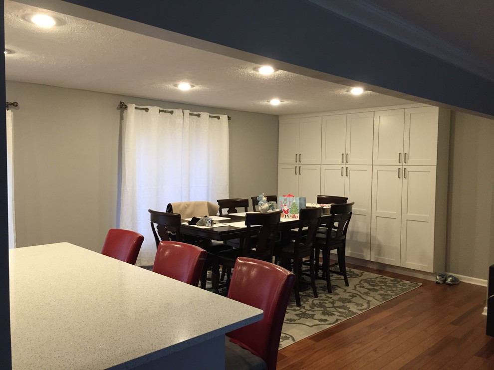 Photo of a medium sized modern kitchen/dining room in Indianapolis with grey walls and dark hardwood flooring.