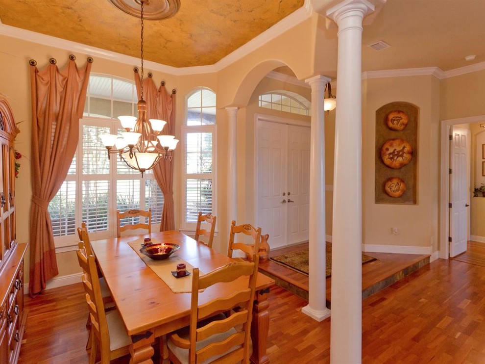 This is an example of a medium sized classic kitchen/dining room in Orlando with beige walls, medium hardwood flooring and no fireplace.