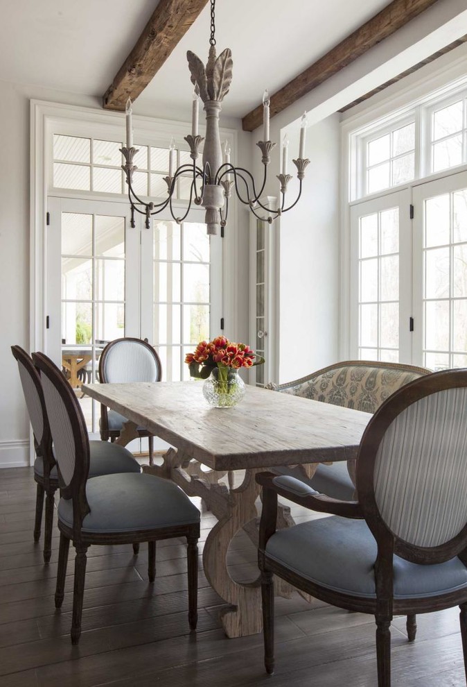 Traditional enclosed dining room with white walls and dark hardwood flooring.