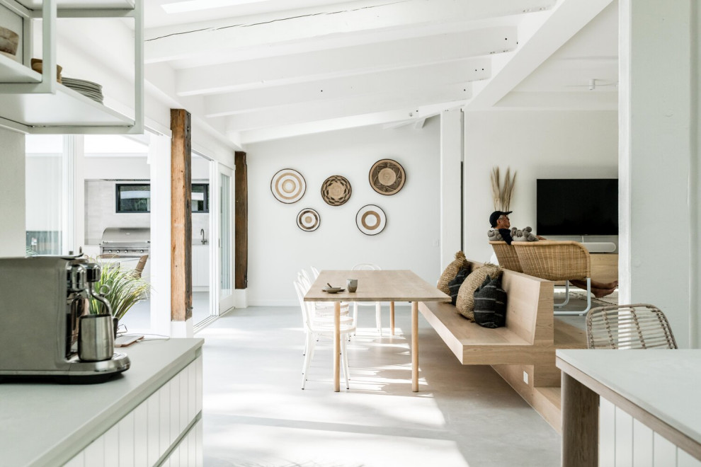 Inspiration for an expansive nautical open plan dining room in Sunshine Coast with white walls, concrete flooring and grey floors.