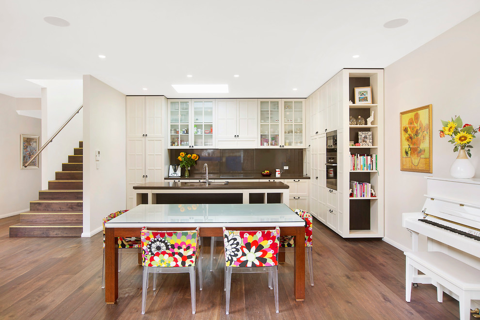 Example of a large trendy dark wood floor kitchen/dining room combo design in Sydney with beige walls