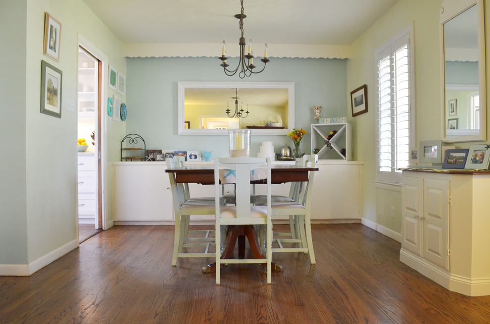 Coastal dining room in Dallas with blue walls and dark hardwood flooring.