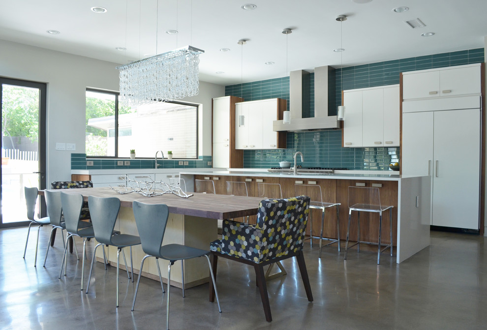 Esempio di una sala da pranzo aperta verso la cucina design con pavimento in cemento