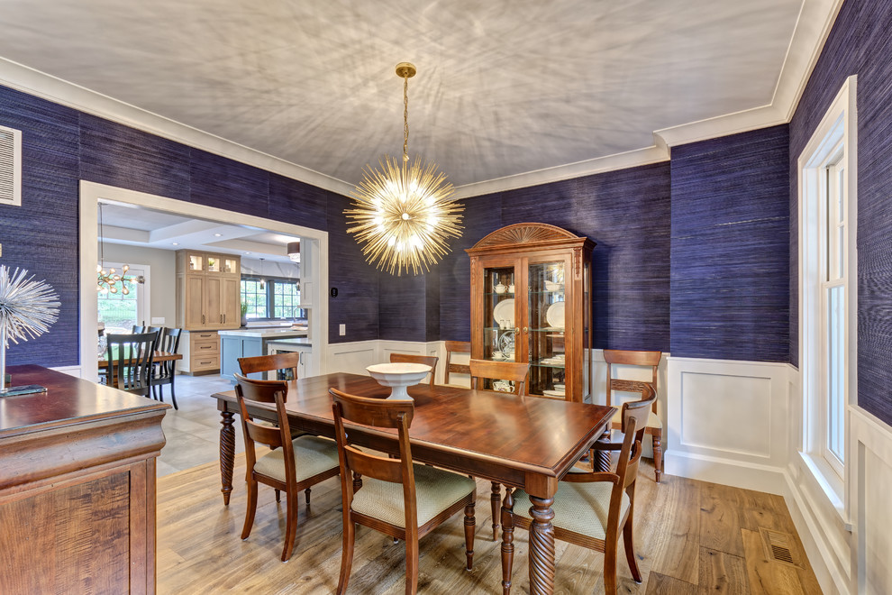 Example of a transitional light wood floor enclosed dining room design in New York with blue walls and no fireplace