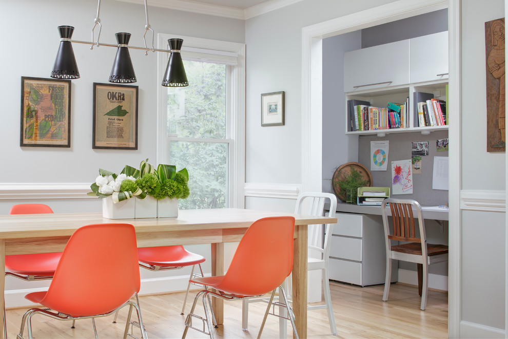 Enclosed dining room - transitional light wood floor enclosed dining room idea in Raleigh with gray walls