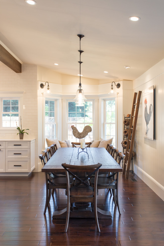 Farmhouse kitchen/dining room in San Francisco with dark hardwood flooring, brown floors and beige walls.