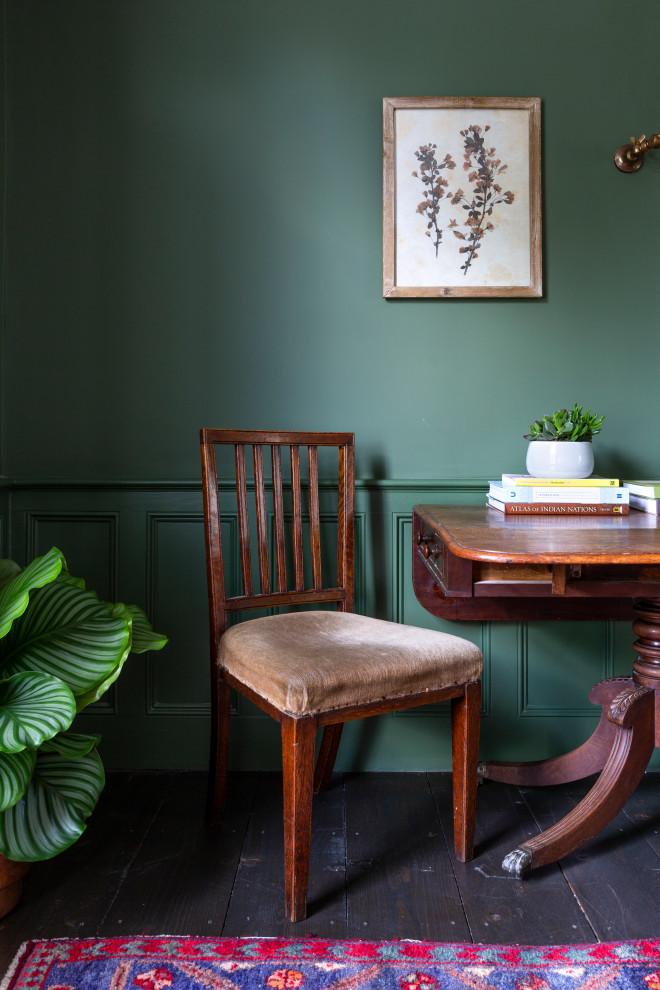 Mittelgroße Eklektische Wohnküche mit grüner Wandfarbe, dunklem Holzboden, Kaminofen, Kaminumrandung aus Backstein und braunem Boden in London