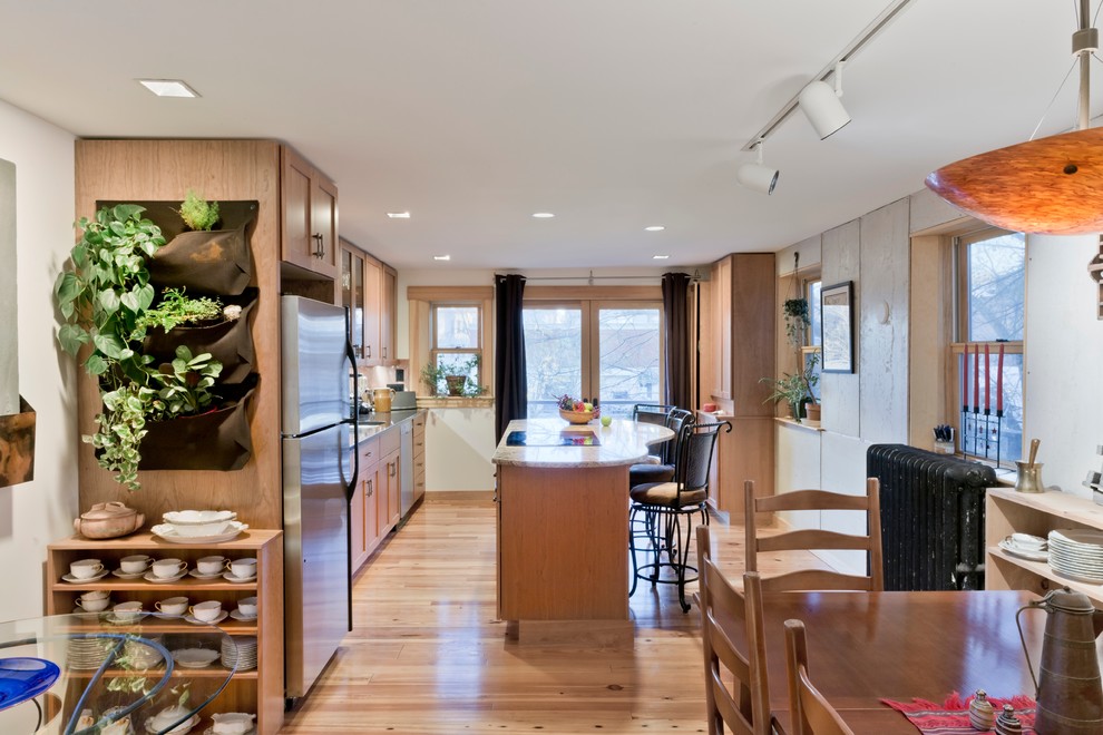 Photo of a medium sized modern kitchen/dining room in Boston with light hardwood flooring.