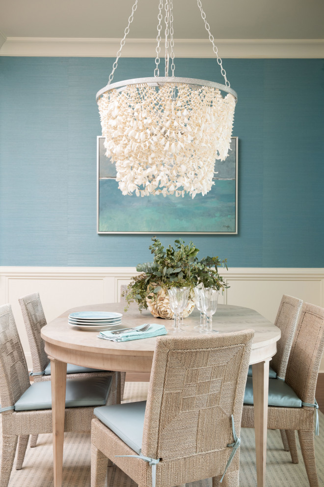 Example of a beach style medium tone wood floor, brown floor and wainscoting dining room design in Other with blue walls