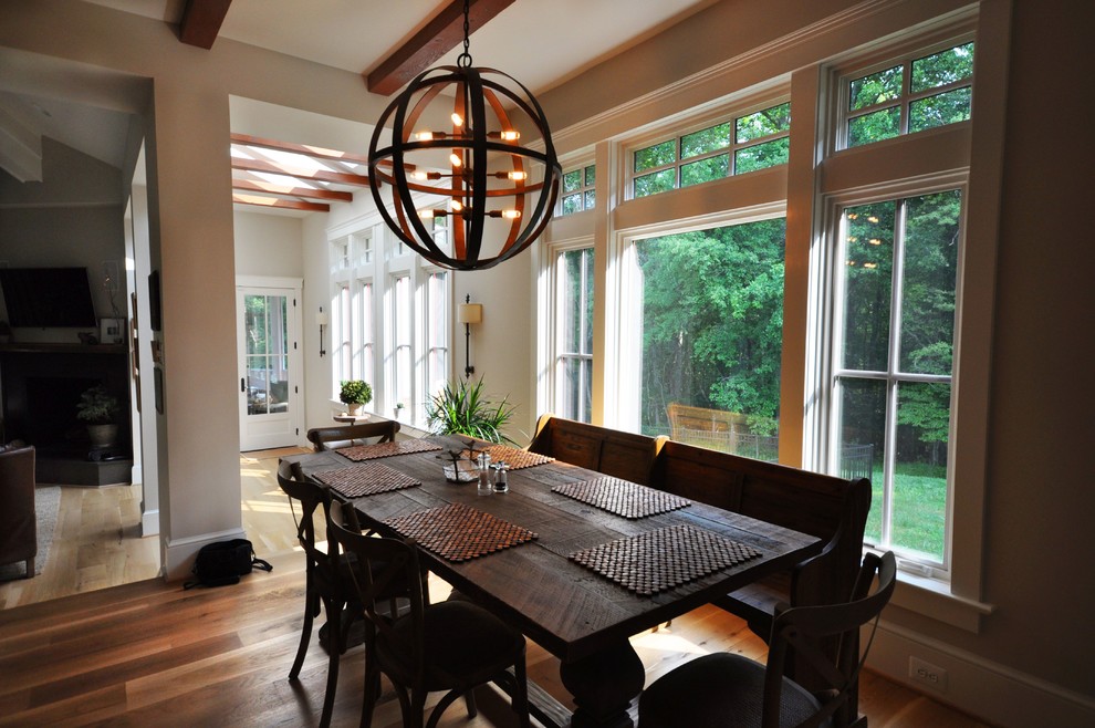 Photo of a medium sized classic open plan dining room in DC Metro with beige walls, medium hardwood flooring, brown floors and no fireplace.