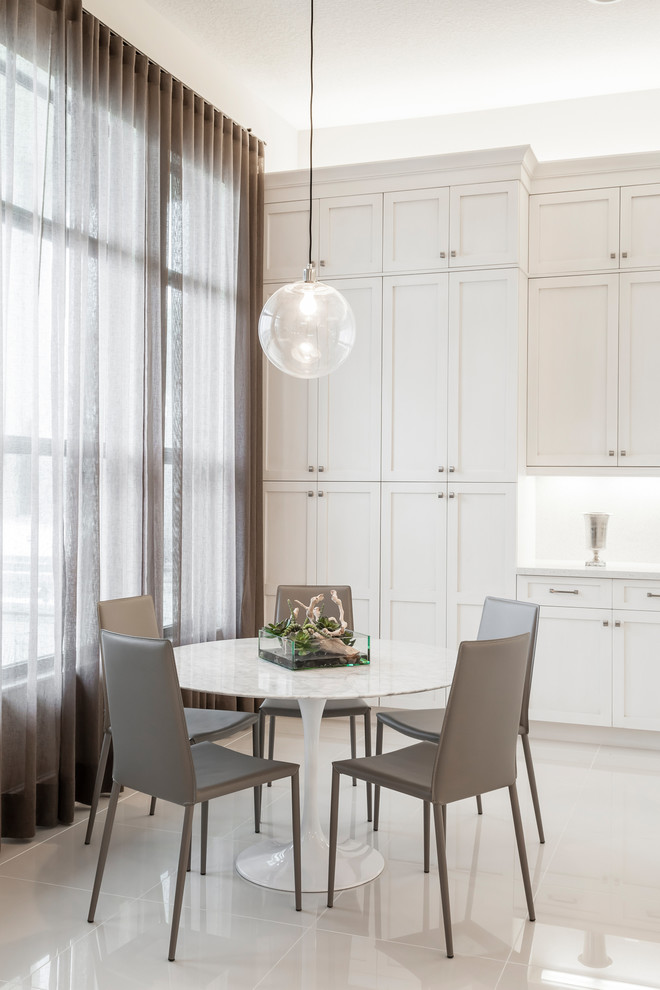 Transitional kitchen/dining room combo photo in Miami with white walls