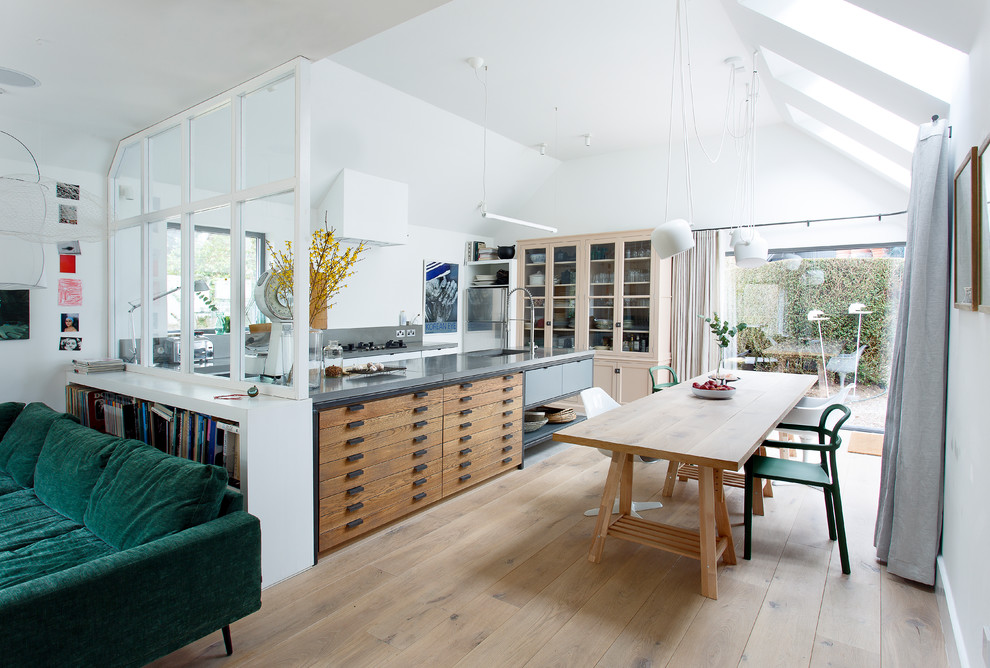 Medium sized modern open plan dining room in Other with light hardwood flooring, brown floors, white walls and no fireplace.