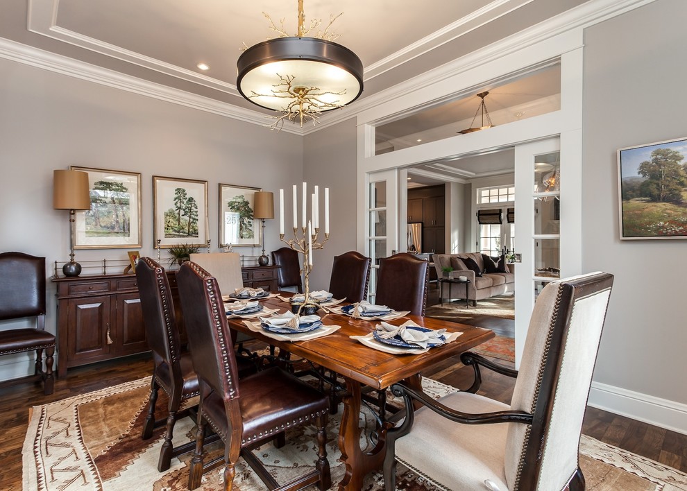 This is an example of a medium sized classic enclosed dining room in Denver with grey walls, medium hardwood flooring, no fireplace and feature lighting.