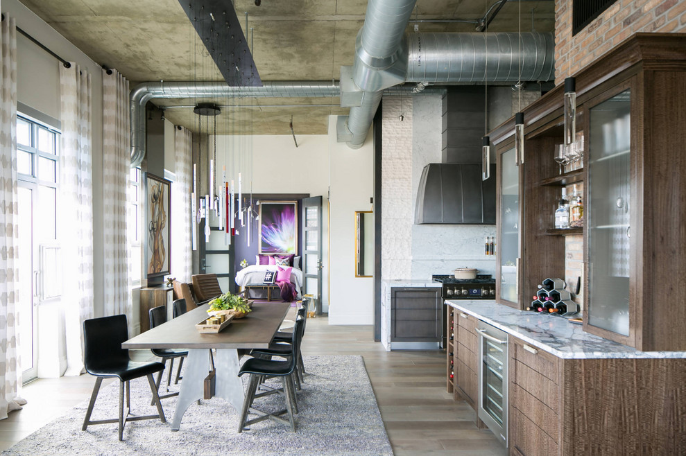 Inspiration for an industrial dark wood floor and brown floor great room remodel in Seattle with white walls