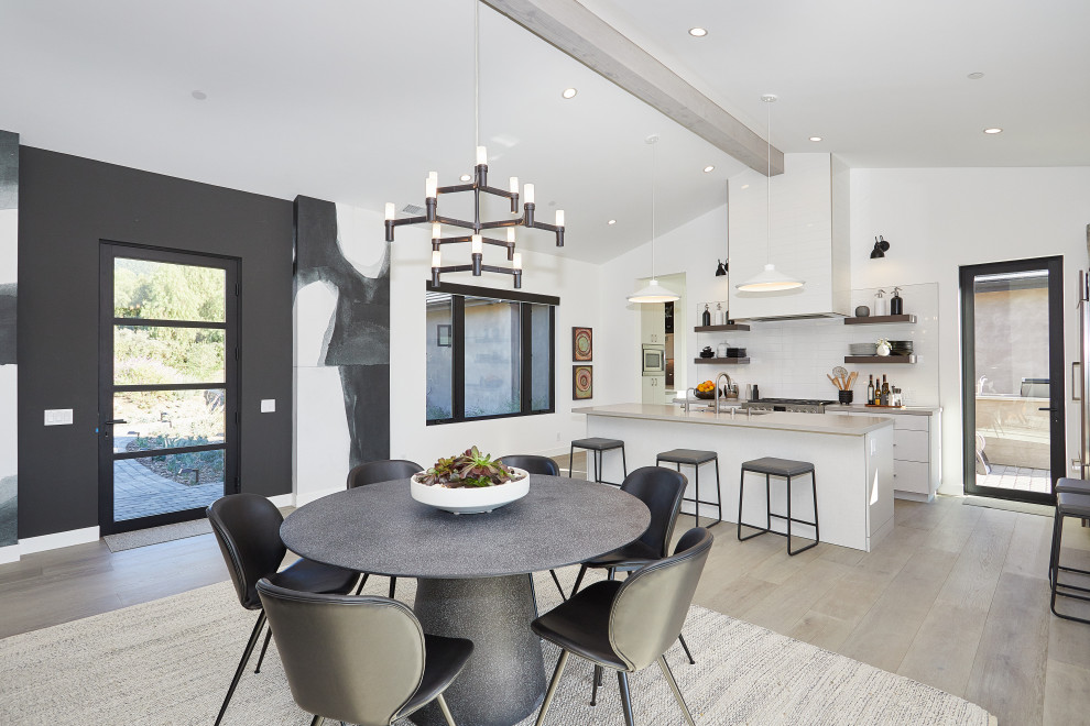 Medium sized contemporary kitchen/dining room in Dallas with black walls, light hardwood flooring, no fireplace and beige floors.